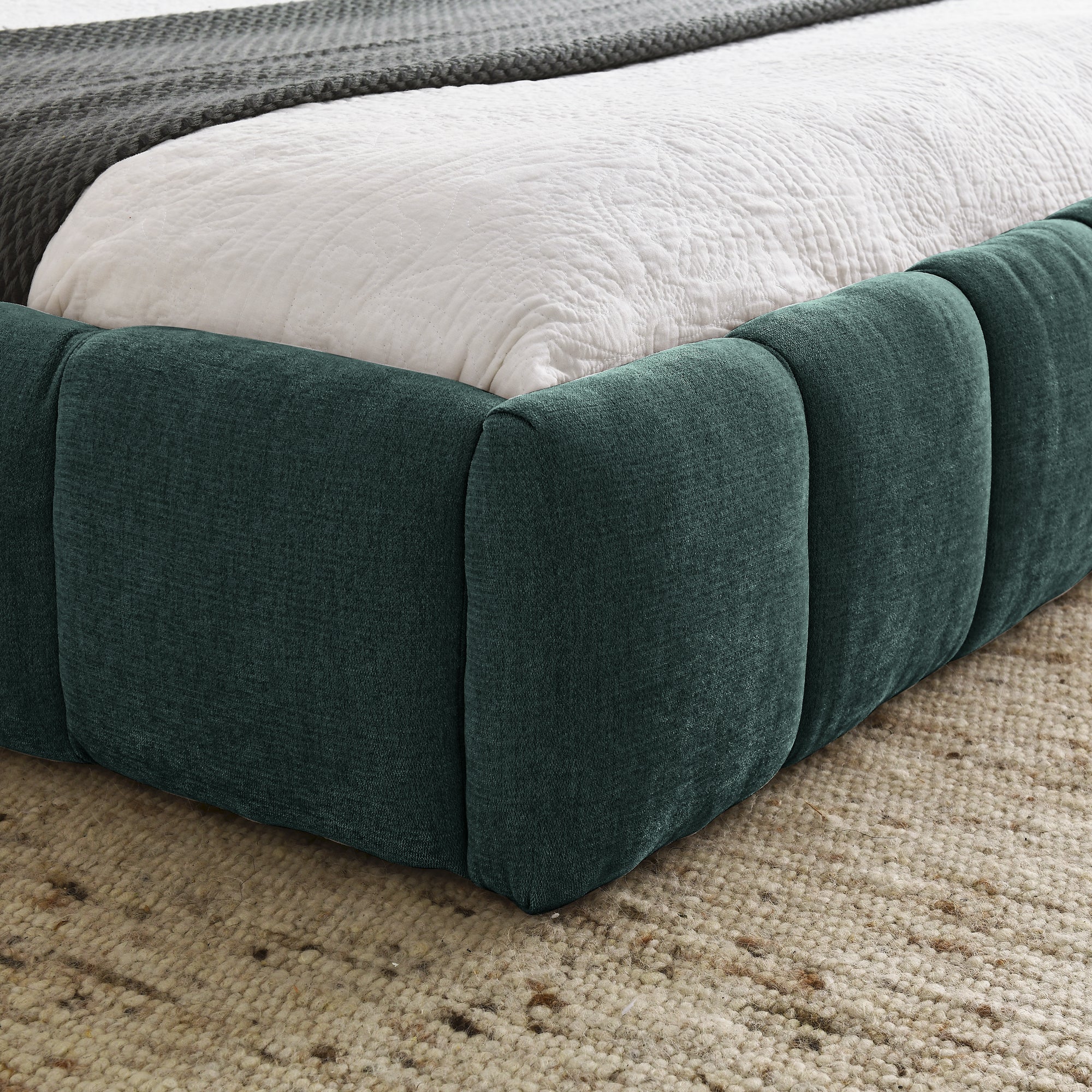 Large soft-padded bed frame in blue-green color