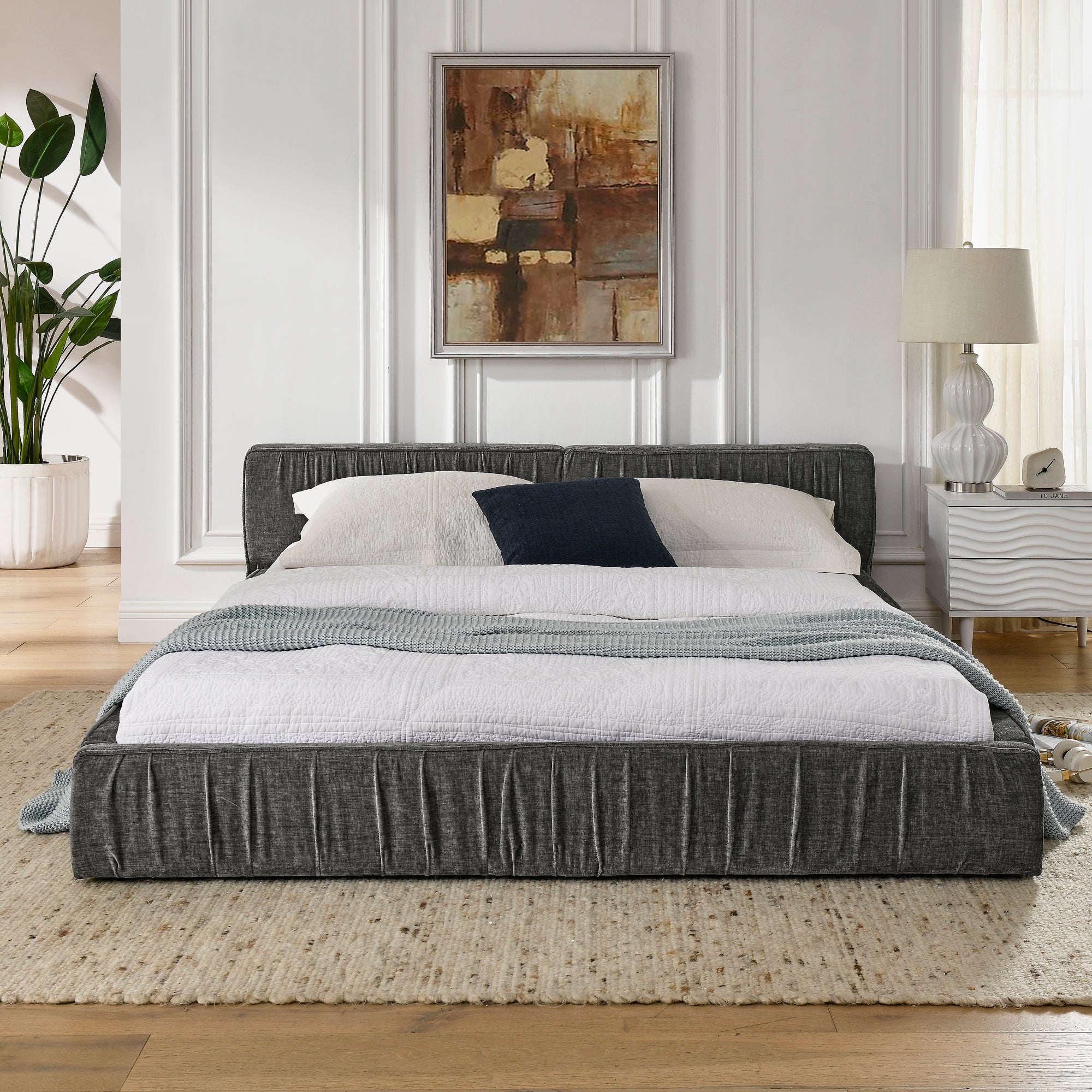 The large grey padded bed frame is designed with Chenille fabric