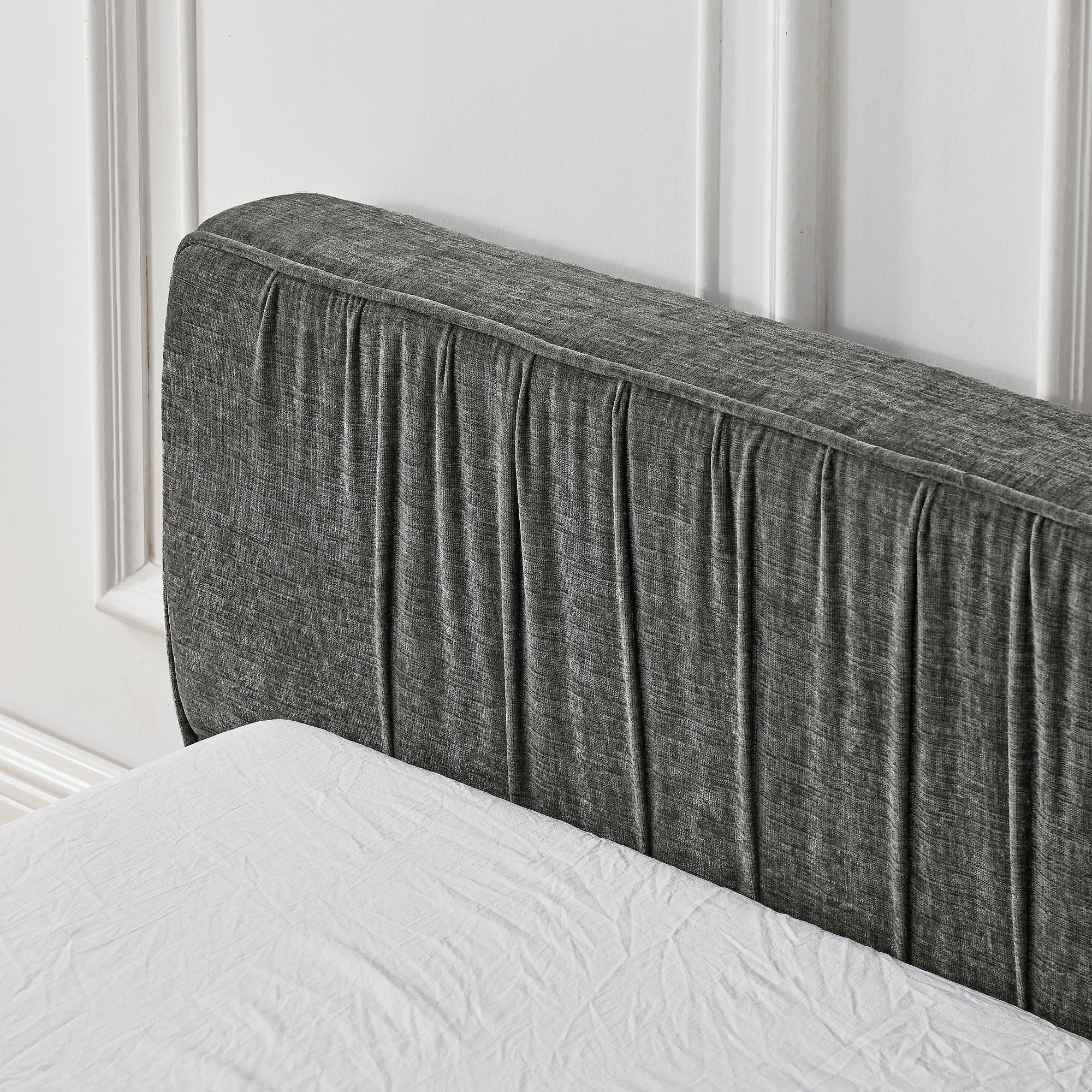 The large grey padded bed frame is designed with Chenille fabric